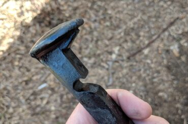 Bottle opener made from a railroad nail or spike.