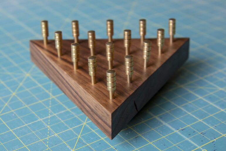Walnut and Brass Triangle Puzzle IQ Puzzle made out of walnut with brass pegs