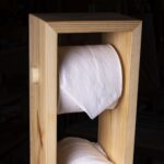 A toilet paper tower made out of scrap pine wood.